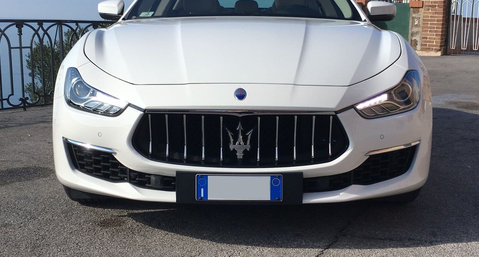 Frontale della nuova Maserati Ghibli Gran Lusso di colore Bianca con interni chiari. Auto molto comoda, fascino dell’eleganza con il tocco sportivo che regala il bellissimo marchio Maserati